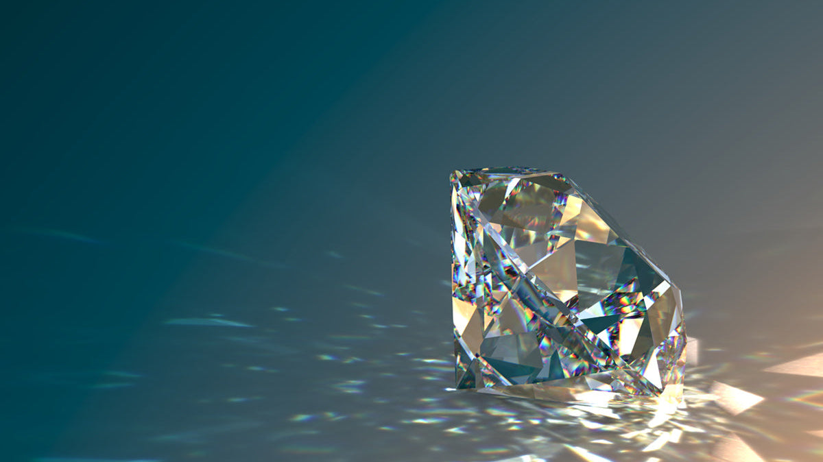 A sparkling diamond showcasing its brilliance and facets on a reflective surface