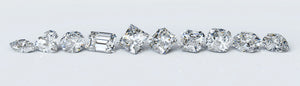 A collection of loose lab grown diamonds in various cuts, demonstrating the range of shapes and sizes available