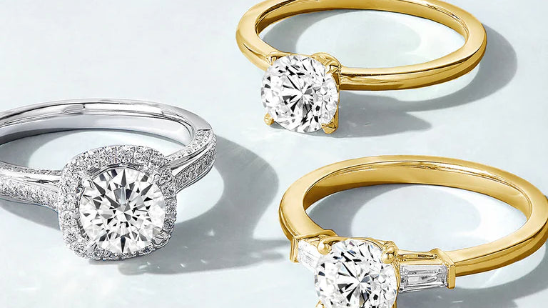 Three diamond rings in different settings and metal colors