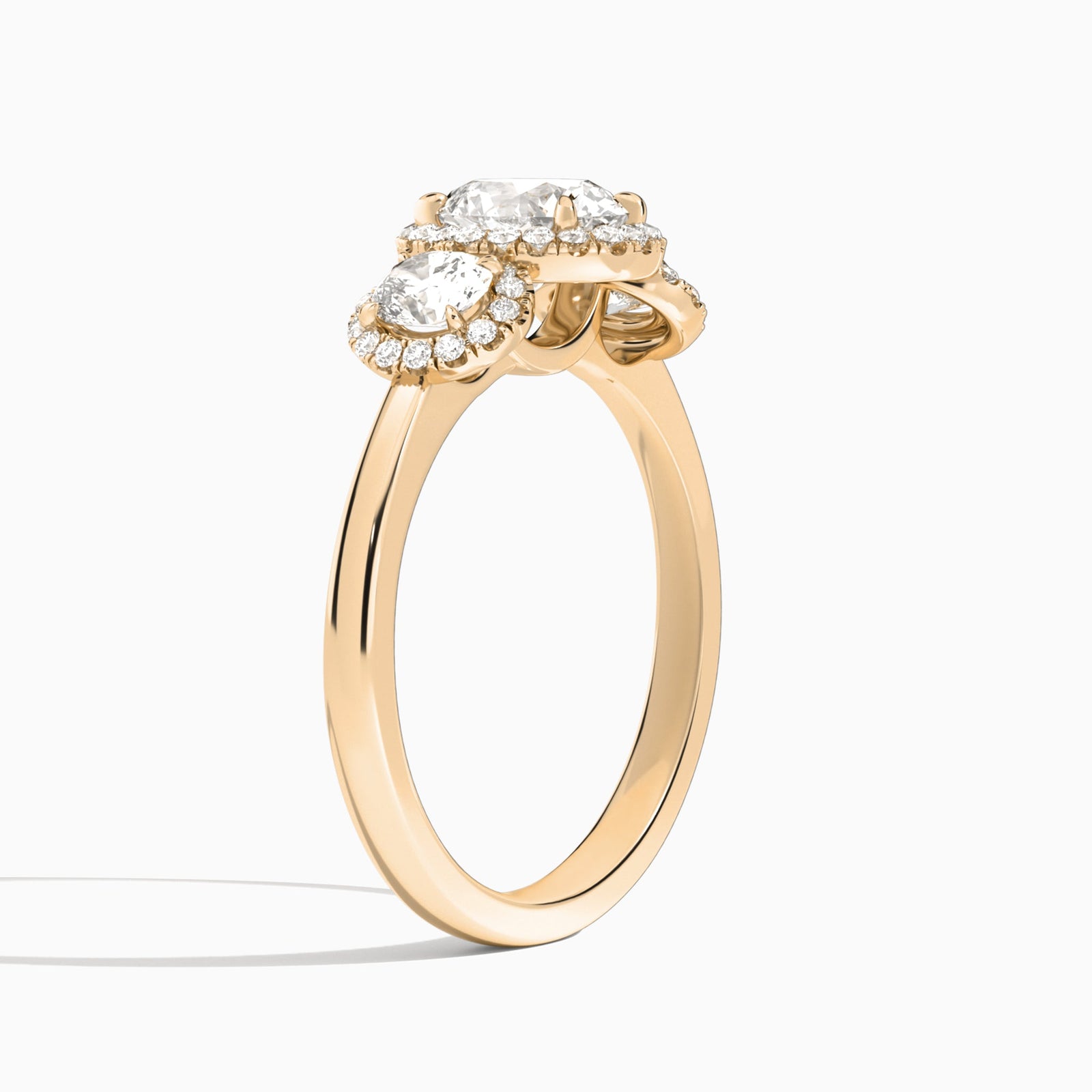 Oval Luxe Three Stone Halo Lab Diamond Engagement Ring In 14K Rose Gold, Angle View