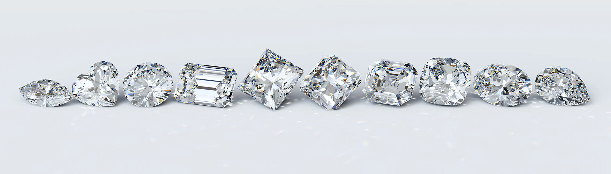 A row of diamonds showcasing different cuts, including round, princess, emerald, and more, highlighting the variety available