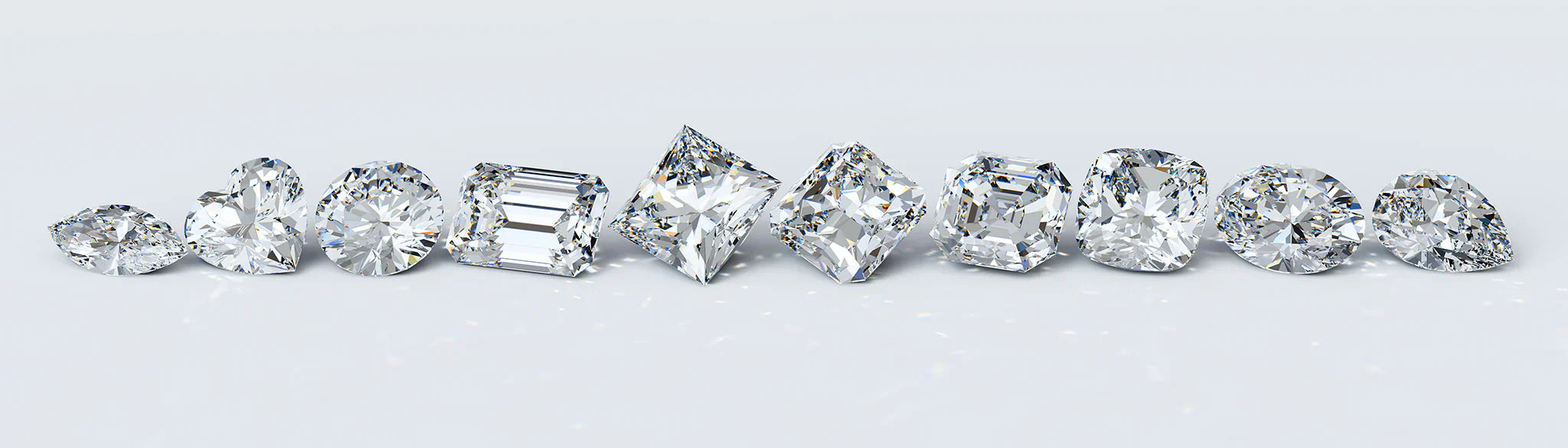 A row of diamonds showcasing different cuts, including round, princess, emerald, and more, highlighting the variety available