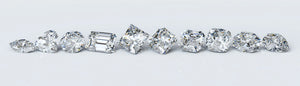 A collection of loose lab grown diamonds in various cuts, demonstrating the range of shapes and sizes available