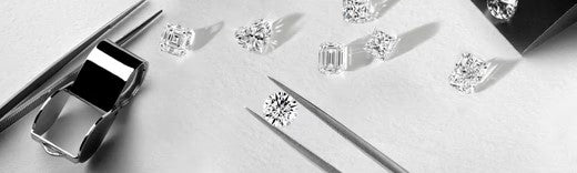 Loose diamonds and tools on a jeweler's workbench