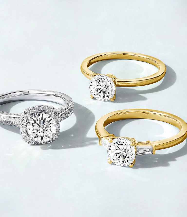 Three diamond rings in different settings and metal colors