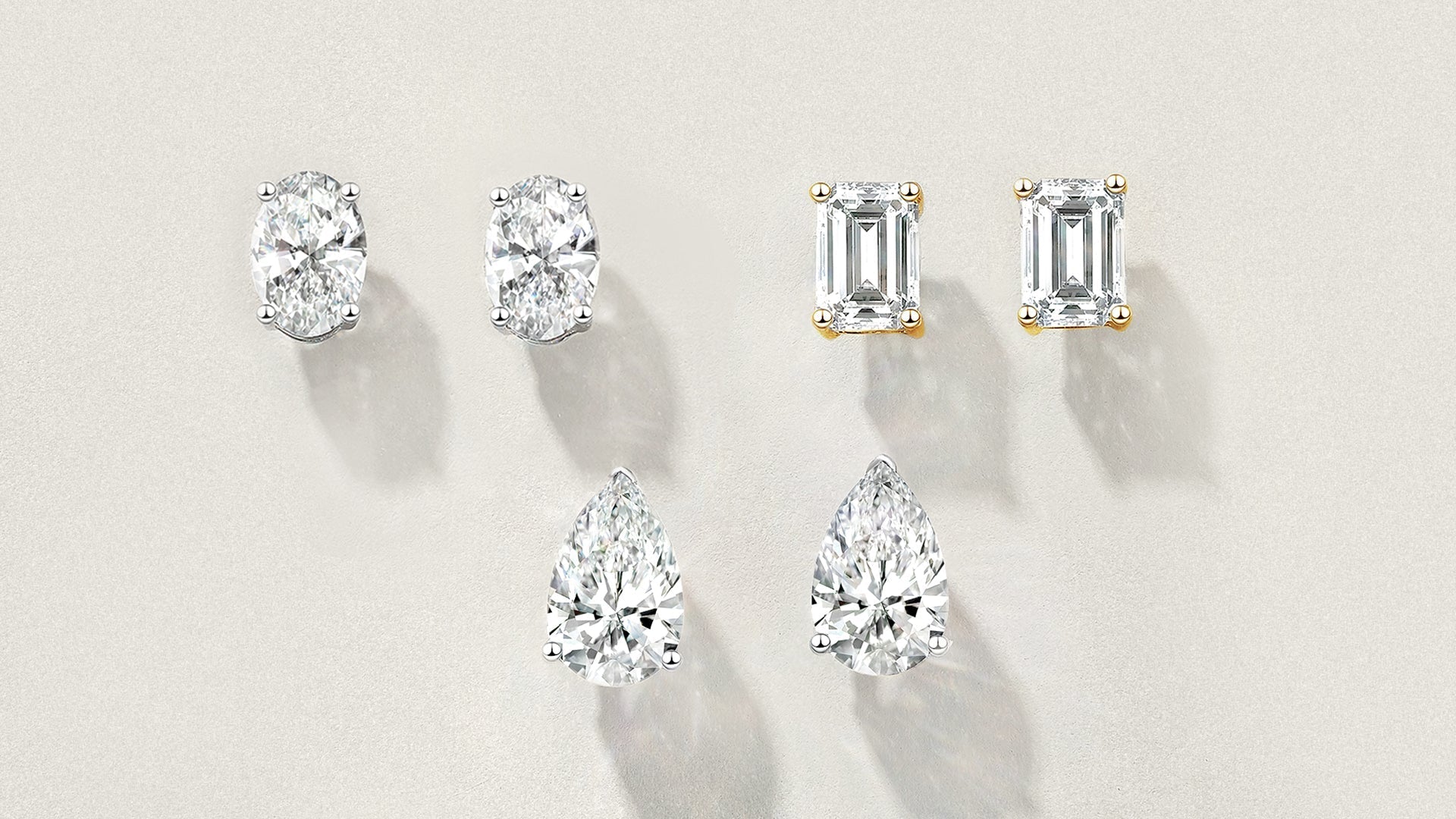 Collection of three pairs of lab-grown diamond stud earrings: oval-cut in silver setting, emerald-cut in gold setting, and pear-shaped in silver setting on white background