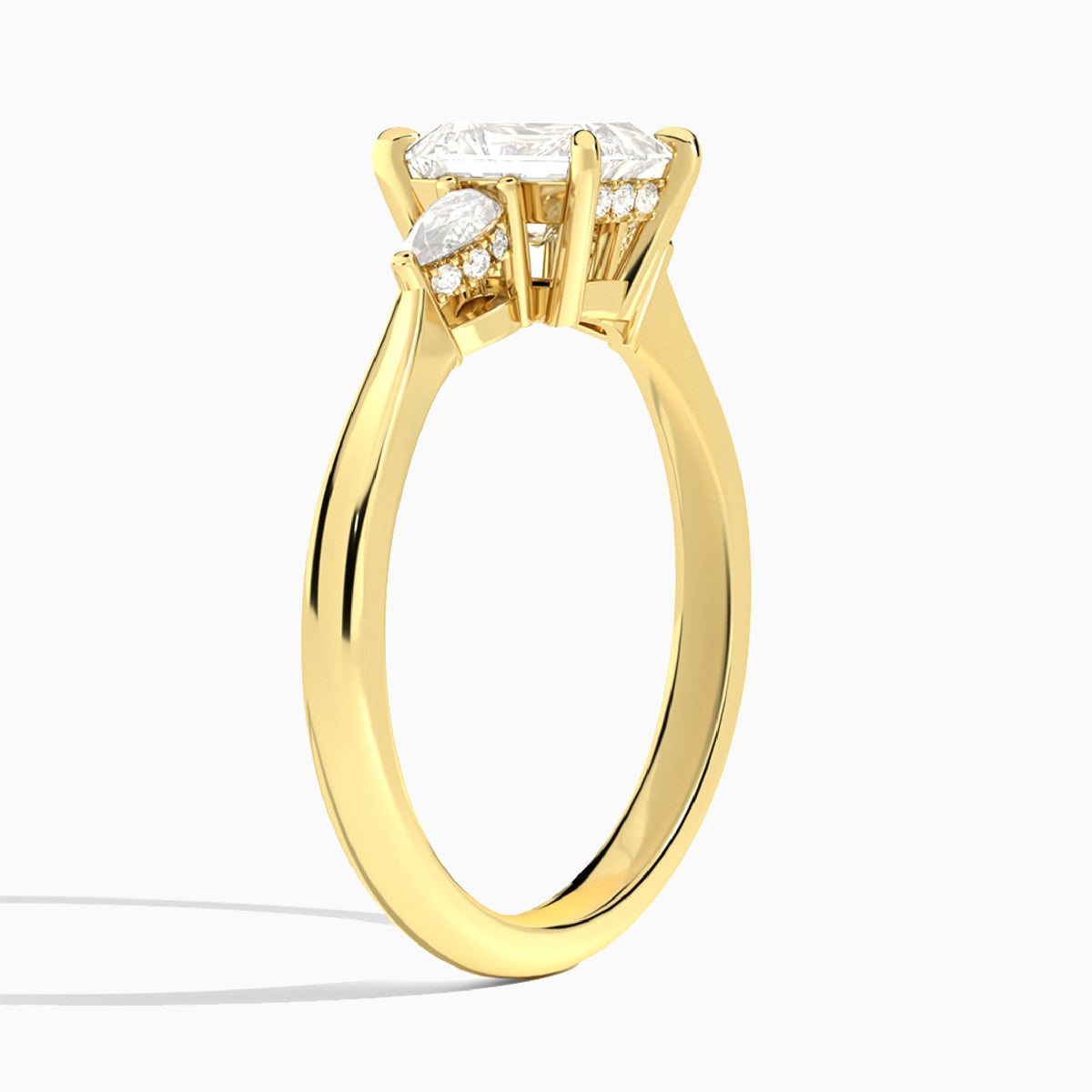 Emerald Adorned Couture Three Stone Lab Diamond Engagement Ring In 18K Yellow Gold, Angle View