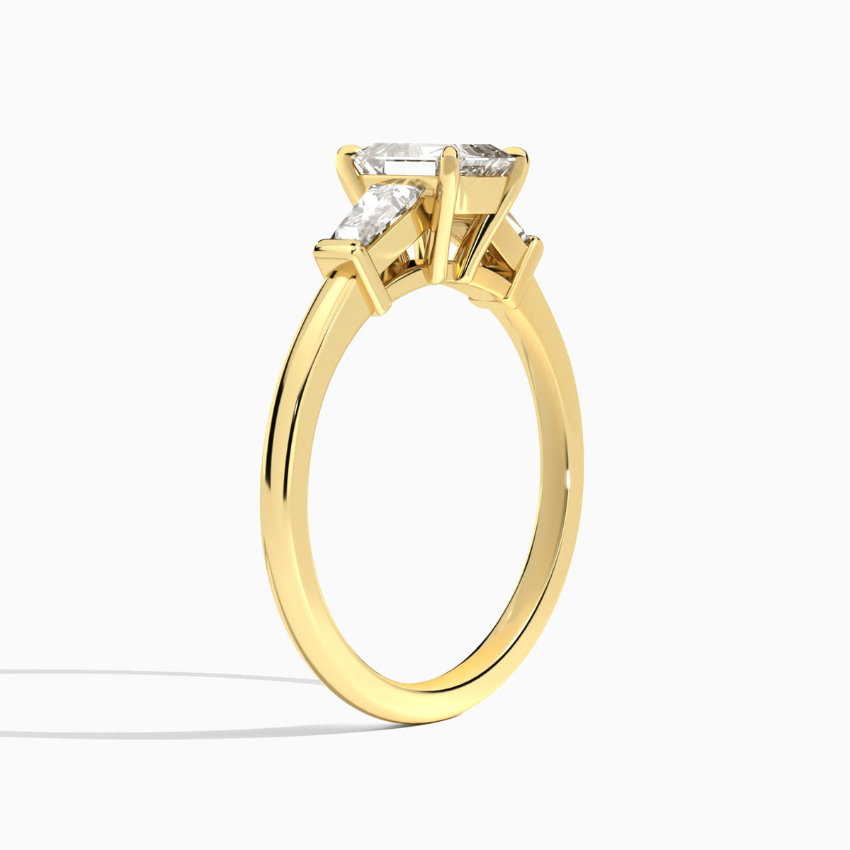 Emerald Thora Three Stone Lab Diamond Engagement Ring In 18K Yellow Gold, Angle View