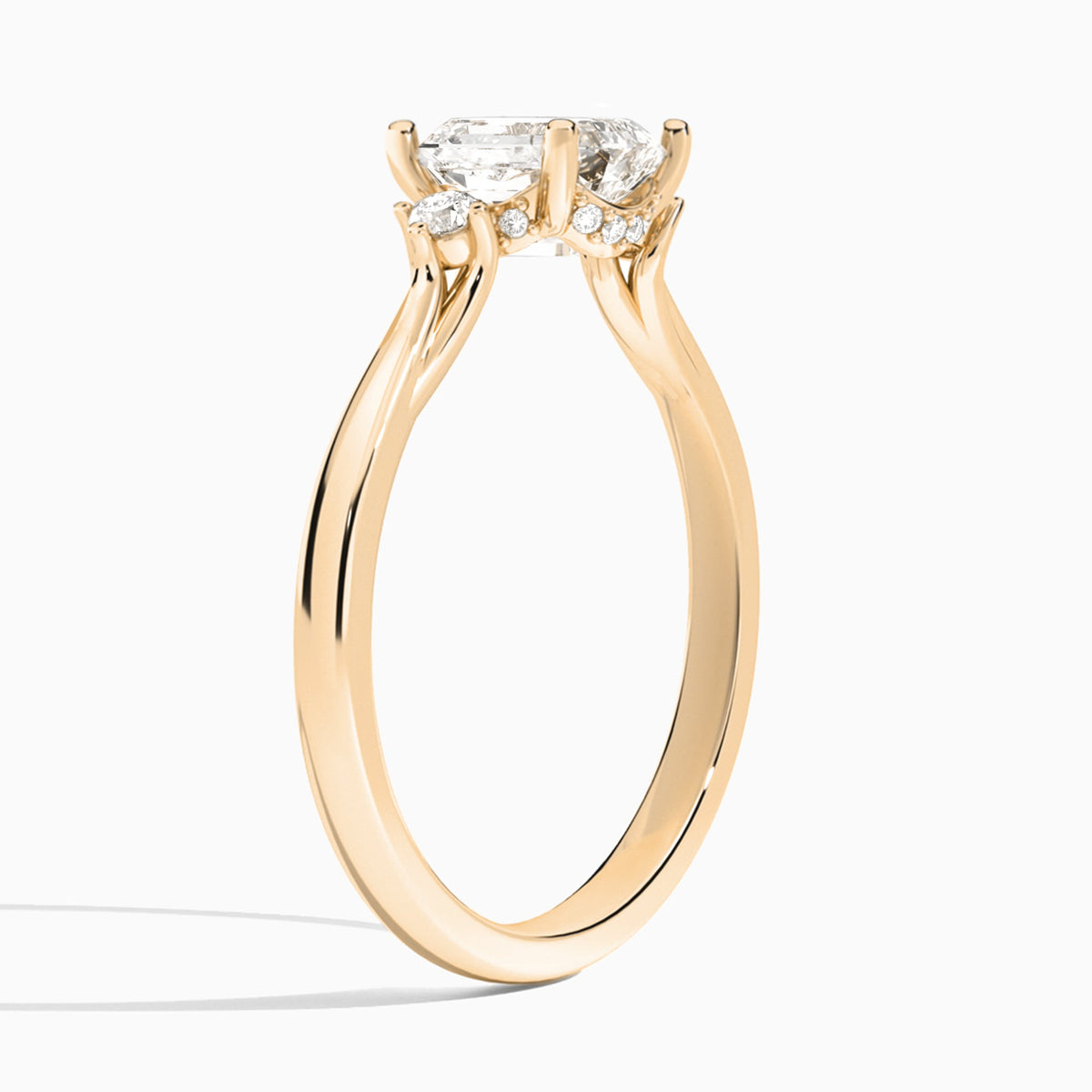 Emerald Floating Three Stone Lab Diamond Engagement Ring In 14K Rose Gold, Angle View