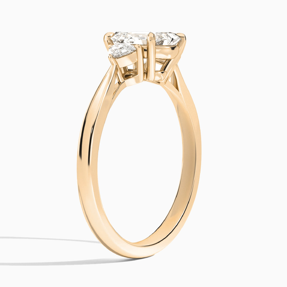 Emerald Trillion Cut Three Stone Lab Diamond Engagement Ring In 14K Rose Gold, Angle View