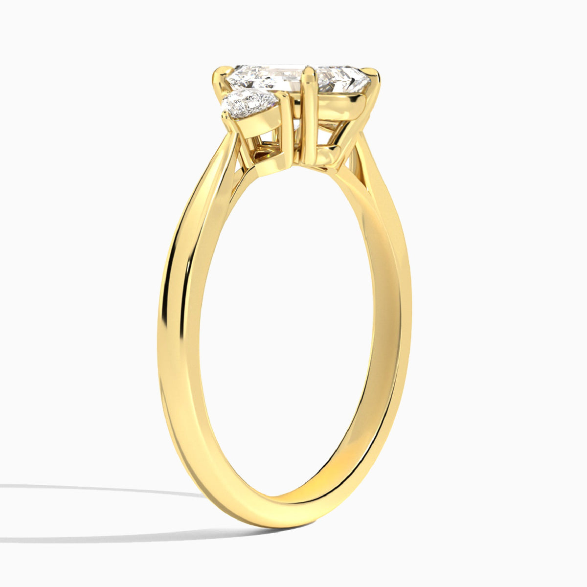 Emerald Trillion Cut Three Stone Lab Diamond Engagement Ring In 18K Yellow Gold, Angle View