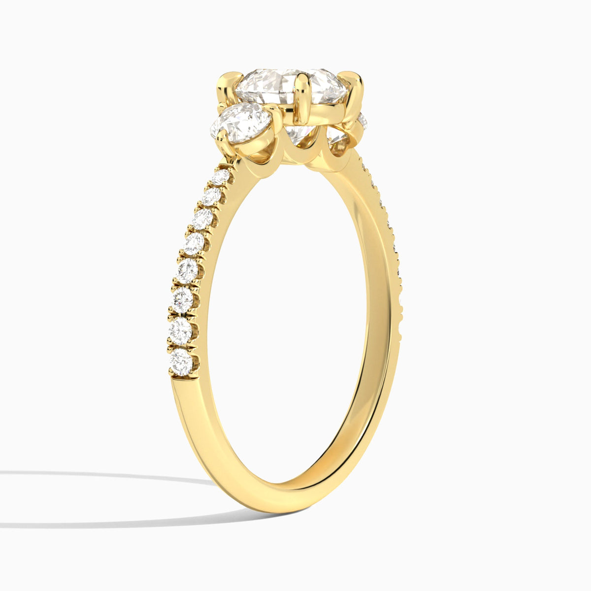 Round Luxe Three Stone Pavé Lab Diamond Engagement Ring In 18K Yellow Gold, Angle View
