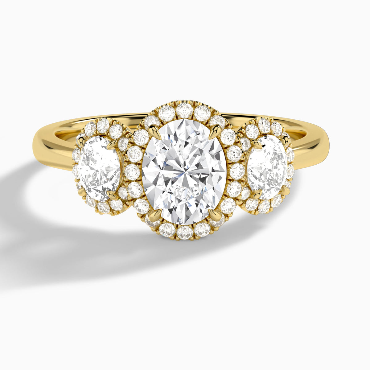 Oval Luxe Three Stone Halo Lab Diamond Engagement Ring In 18K Yellow Gold - Lucenjuri