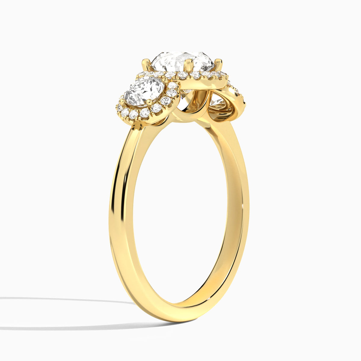 Round Luxe Three Stone Halo Lab Diamond Engagement Ring In 18K Yellow Gold, Angle View