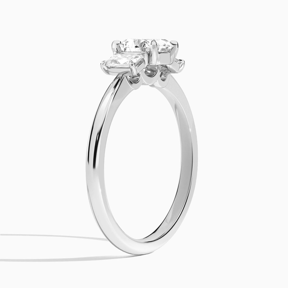 Heart Three Stone Emerald Lab Diamond Engagement Ring In Platinum, Angle View