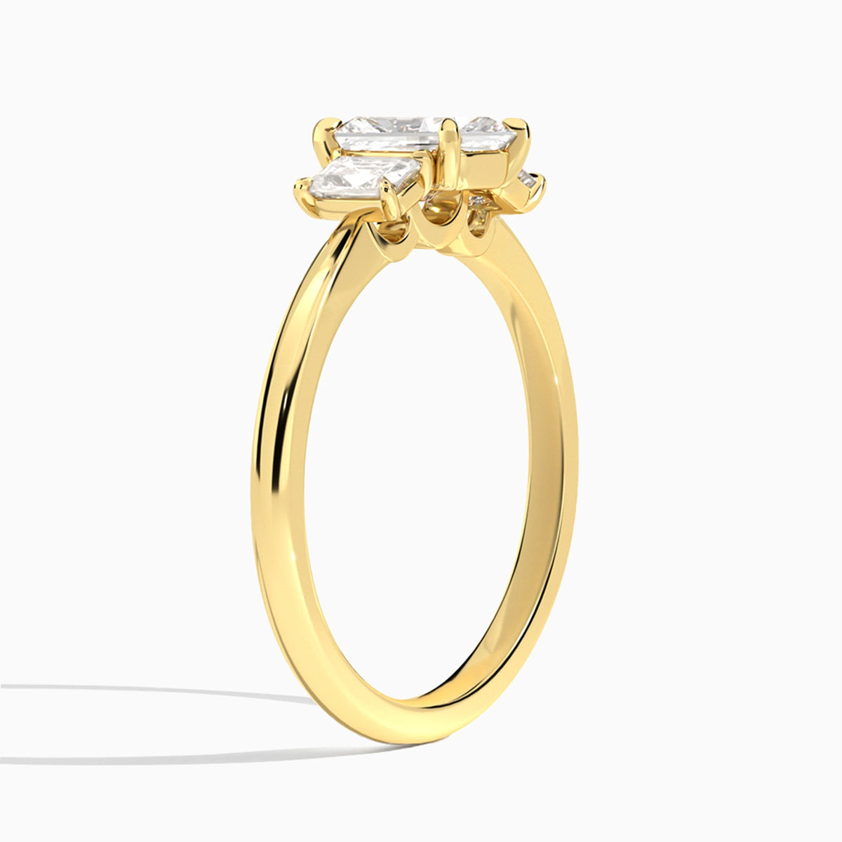 Radiant Three Stone Emerald Lab Diamond Engagement Ring In 18K Yellow Gold, Angle View