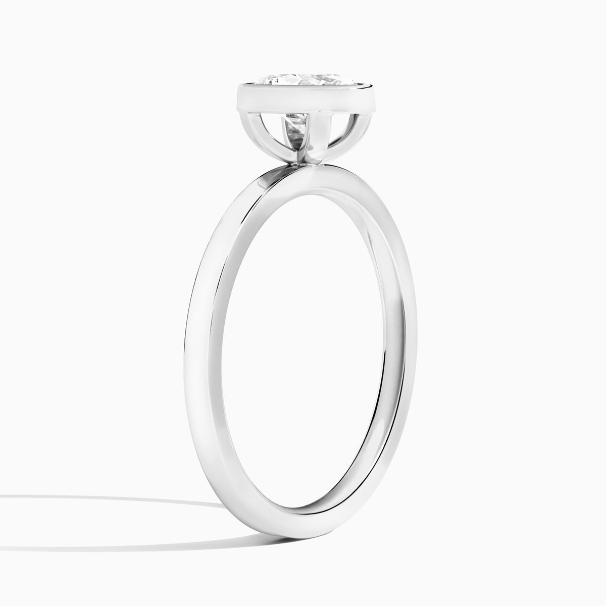 Oval Vera Bezel Set Solitaire Diamond Engagement Ring In Platinum, Angle View