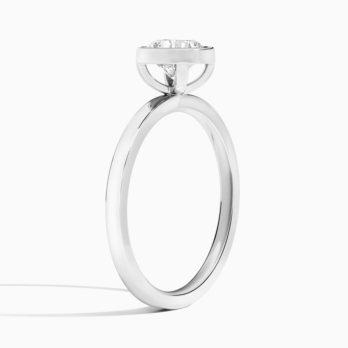 Round Vera Bezel Set Solitaire Diamond Engagement Ring In Platinum, Angle View