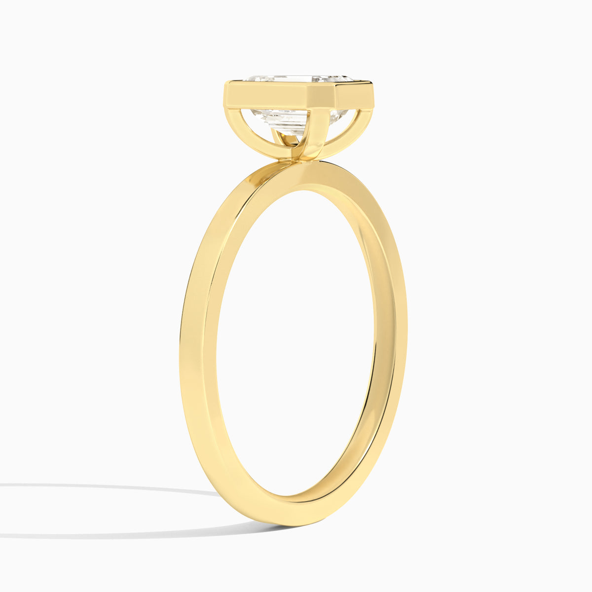 Emerald Vera Bezel Set Solitaire Diamond Engagement Ring In 18K Yellow Gold, Angle View