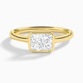 Radiant Alma East-West Bezel Solitaire Diamond Engagement Ring In 18K Yellow Gold - Lucenjuri