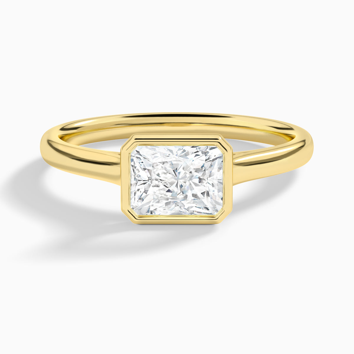 Radiant Alma East-West Bezel Solitaire Diamond Engagement Ring In 18K Yellow Gold - Lucenjuri