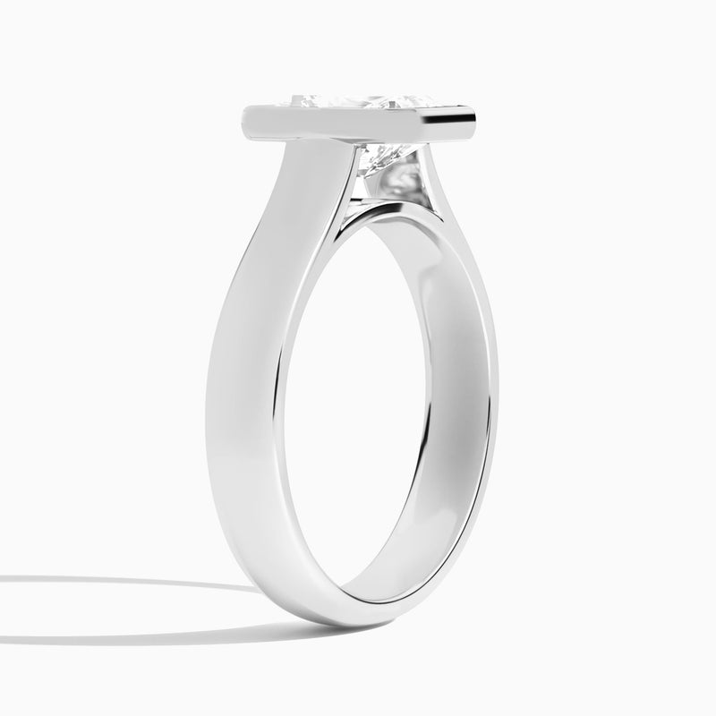 Radiant Alma 4mm Bezel Solitaire Diamond Engagement Ring In Platinum, Angle View