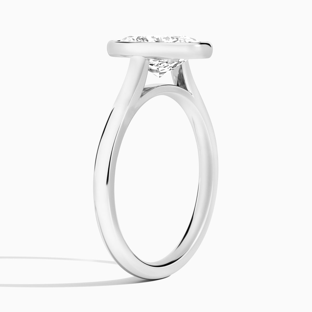 Oval Alma 2mm Bezel Solitaire Diamond Engagement Ring In 18K White Gold, Angle View