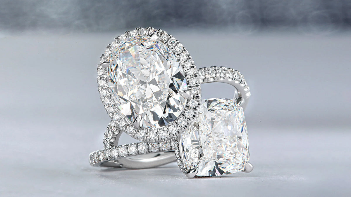 Lab grown diamond engagement ring with a large central lab diamond and accent diamonds on a gray background