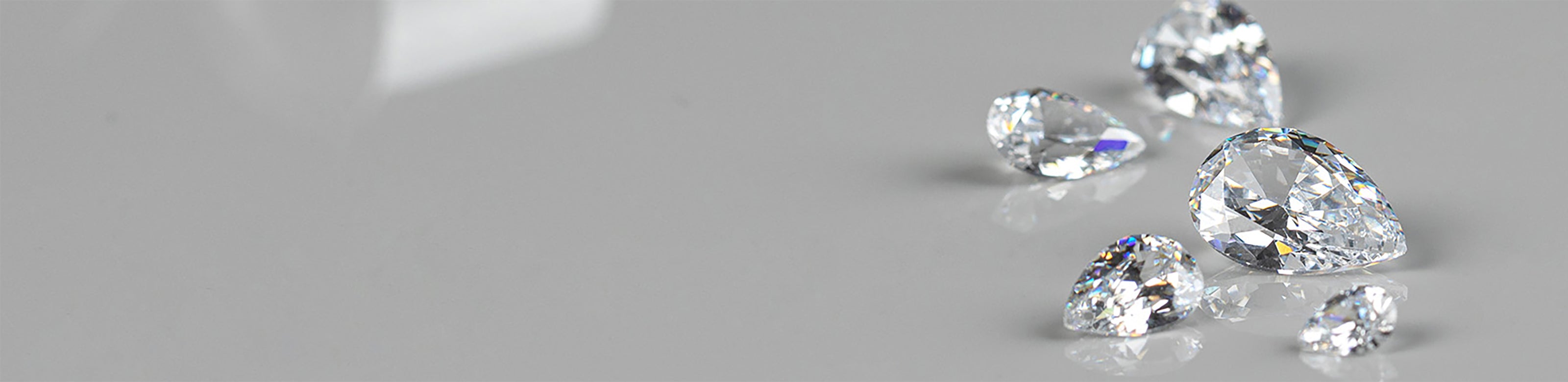 Lab diamonds arranged on a gray surface