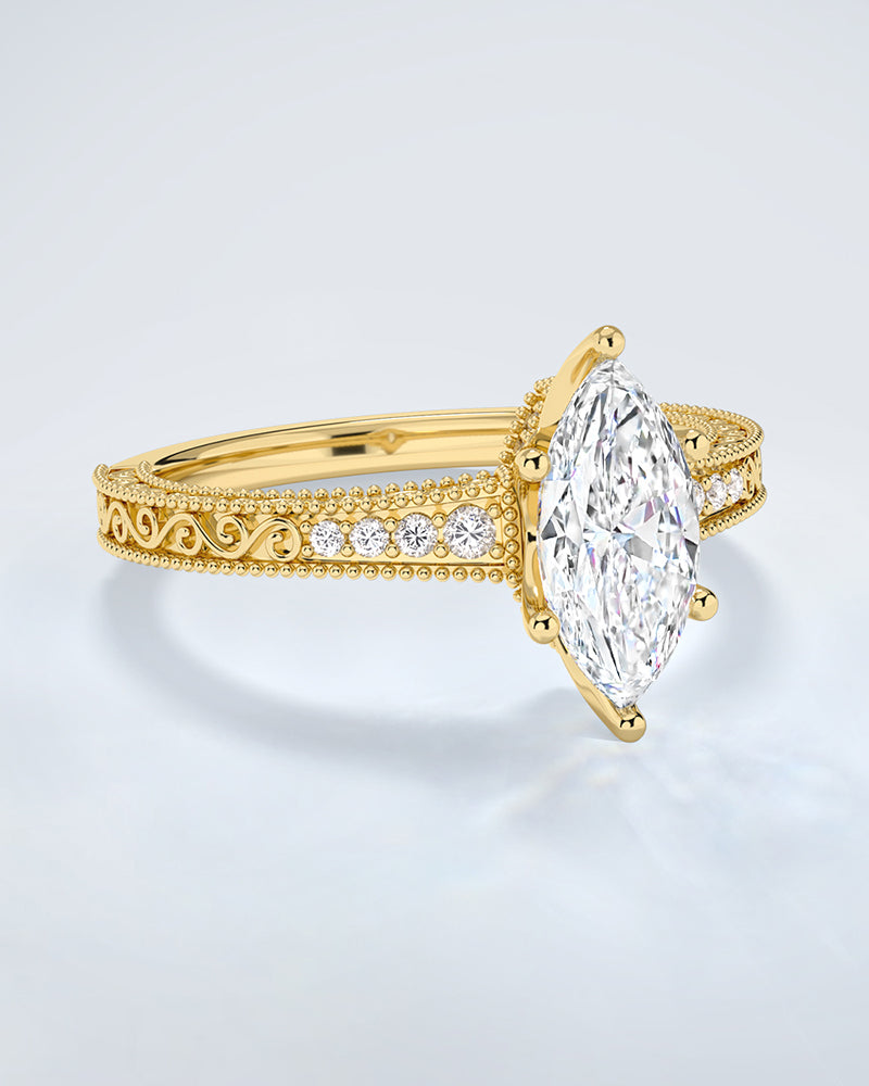 Gold ring with a large lab grown diamond and smaller lab diamonds on a light gray background