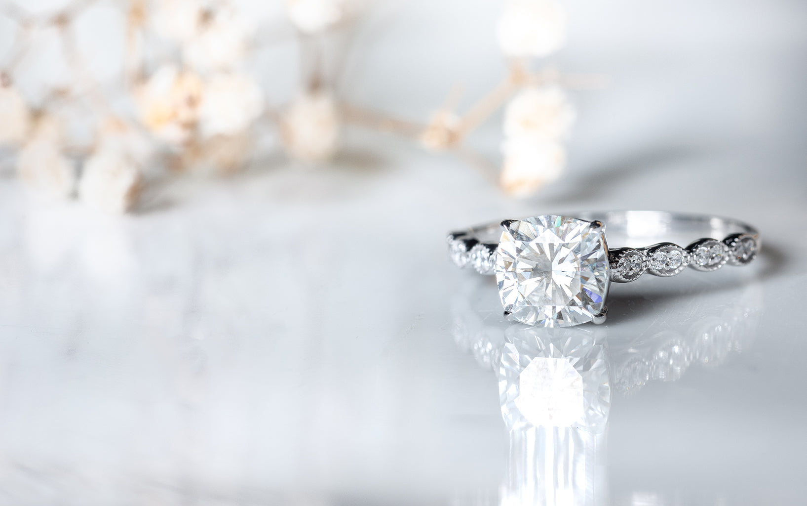 Lab grown diamond engagement ring on a light background