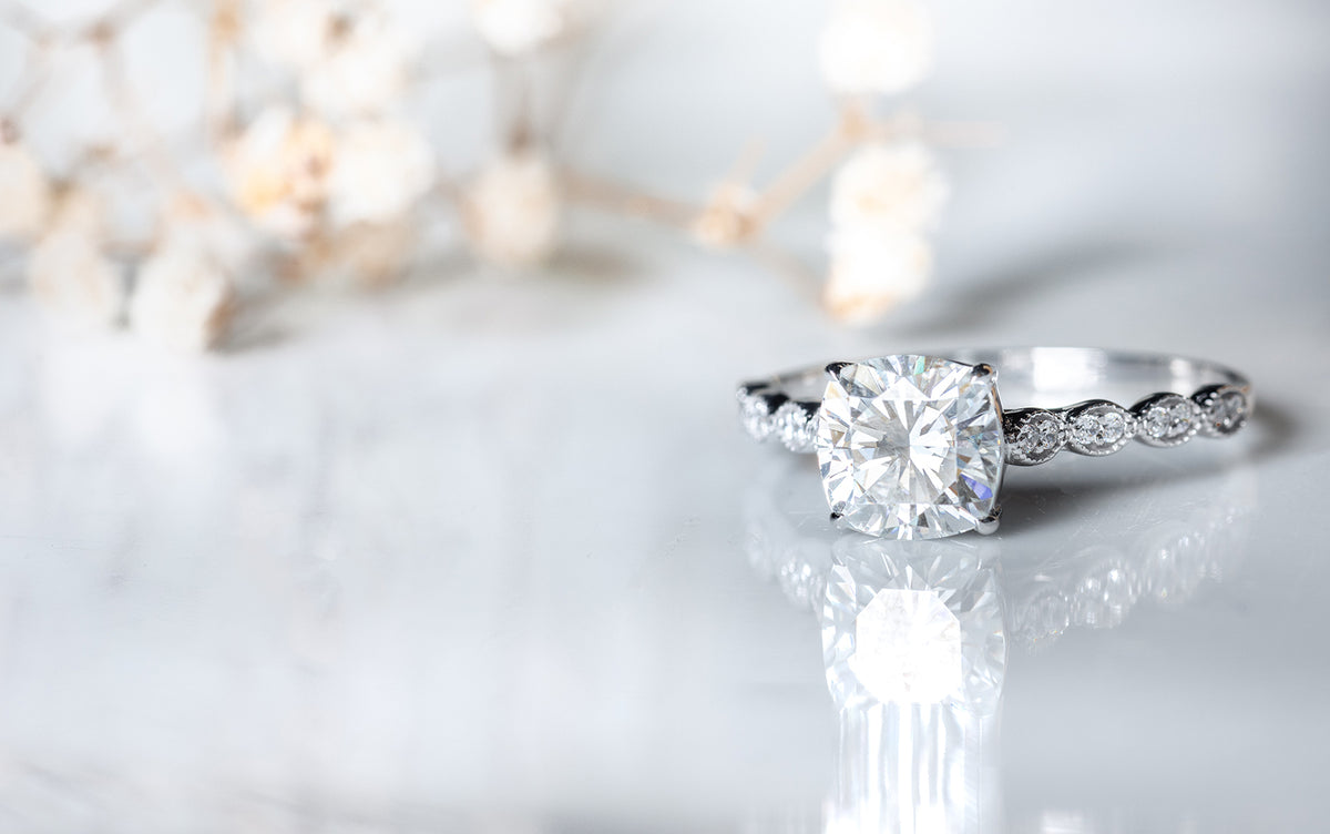 Lab grown diamond engagement ring on a light background