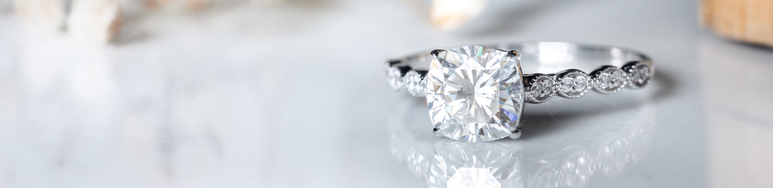 Lab grown diamond engagement ring on a light background