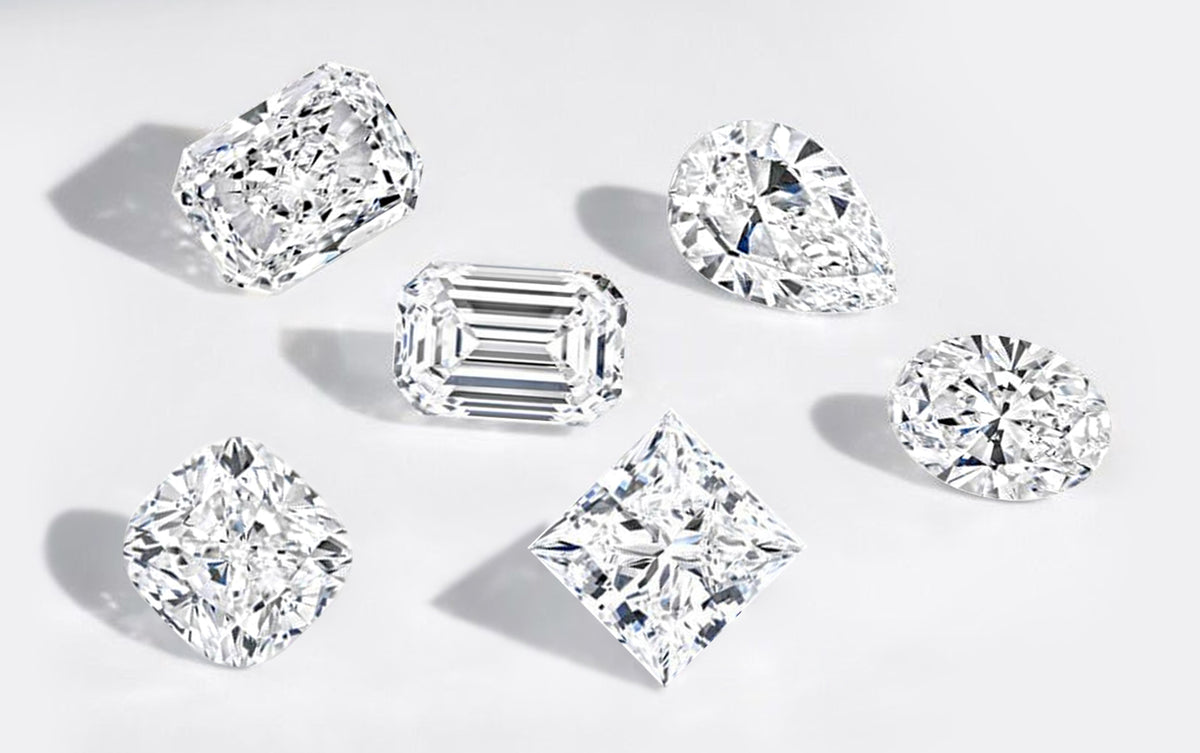 Collection of various cut lab diamonds on a light gray background