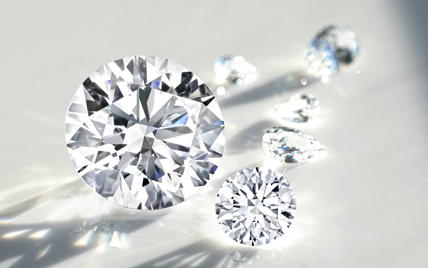 Close-up of round lab diamonds on a reflective surface