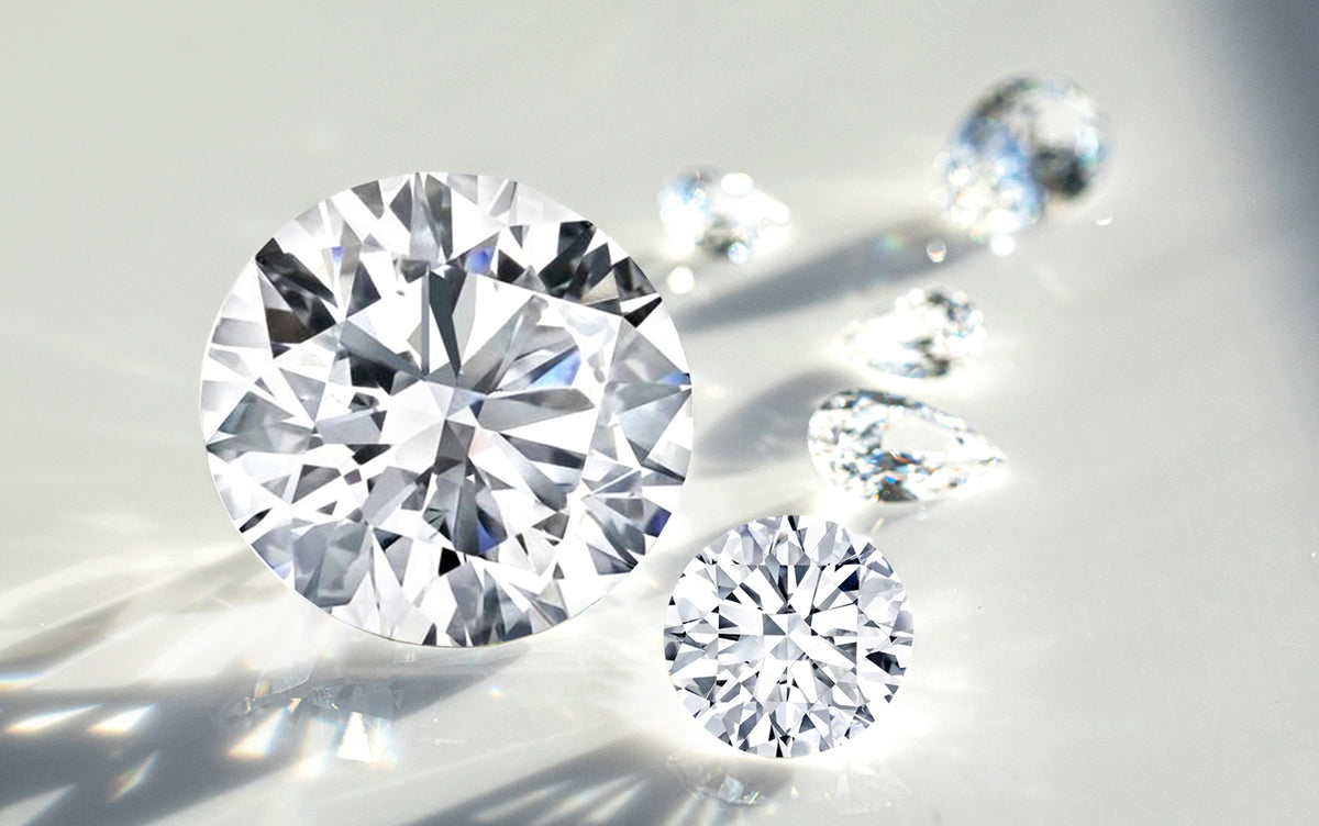 Close-up of round lab diamonds on a reflective surface