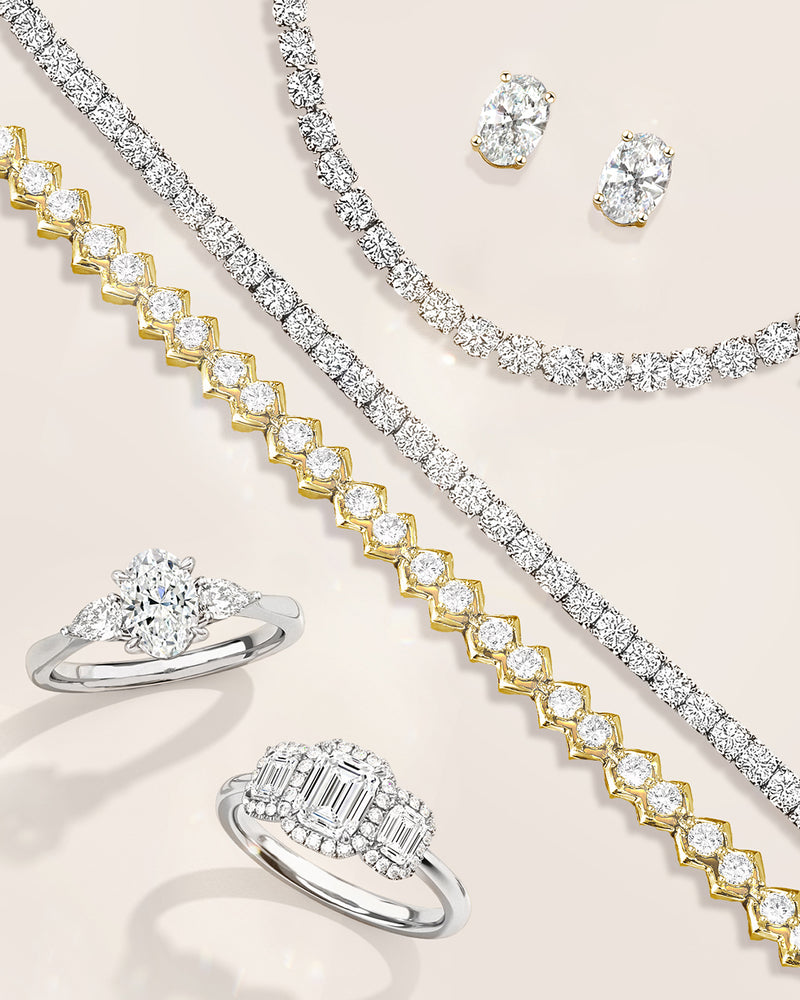 Lab diamond jewelry set including rings and a necklace on a light background