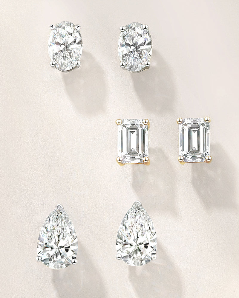 Set of lab diamond earrings on a beige background