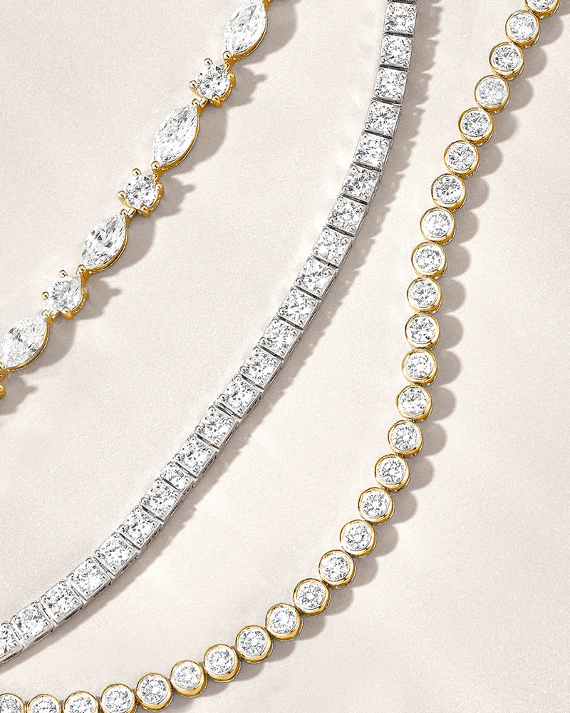 Three lab grown diamond bracelets of different designs on a beige background