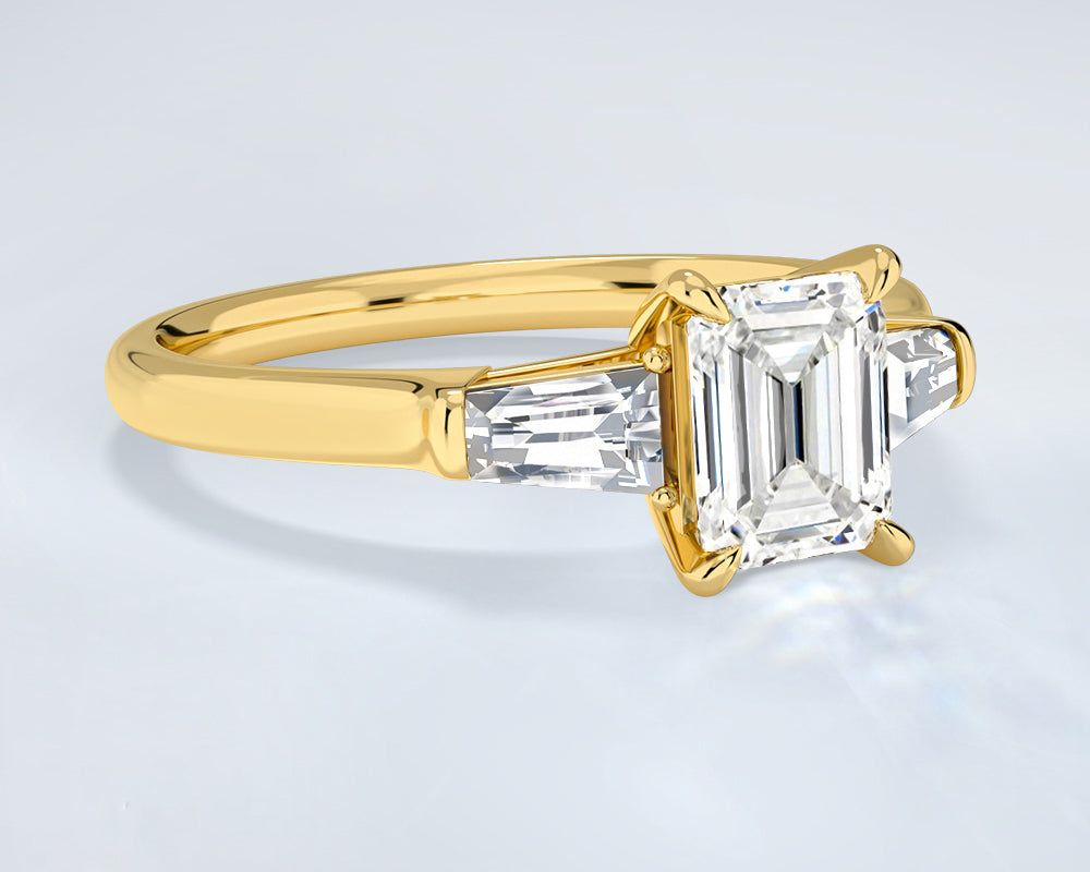 18K yellow gold ring with emerald-cut lab grown diamond on a light gray background