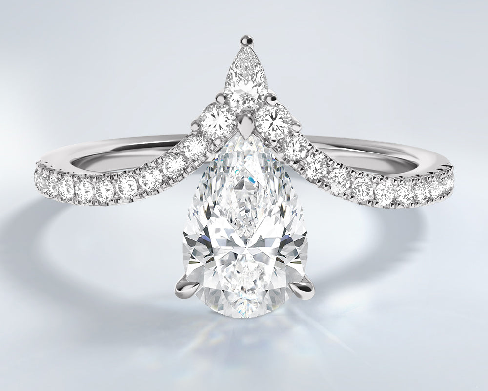 Pear-shaped lab grown diamond ring with a platinum band on a light gray background