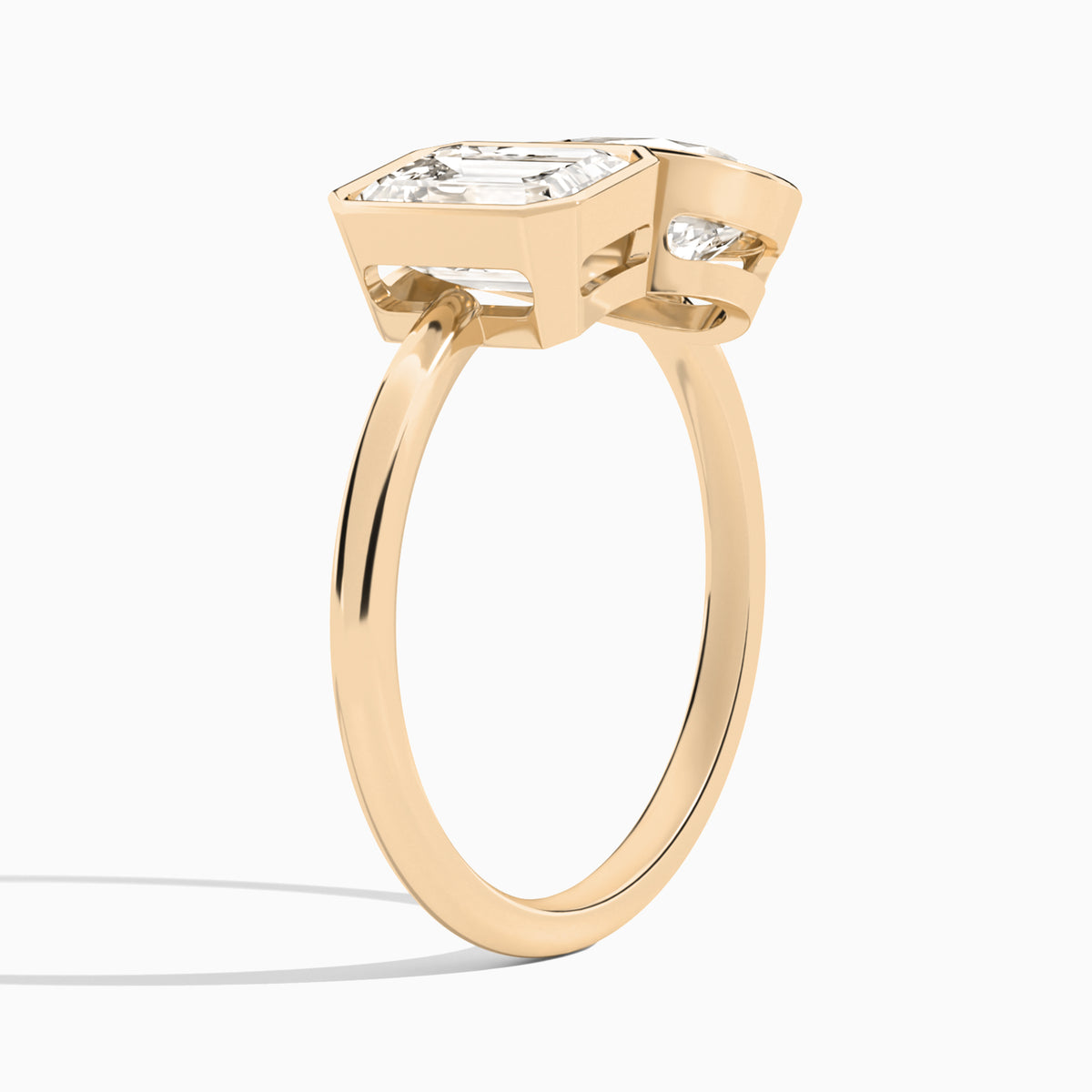 Bezel Toi Et Moi Emerald and Pear Diamond Engagement Ring In 14K Rose Gold, Angle View
