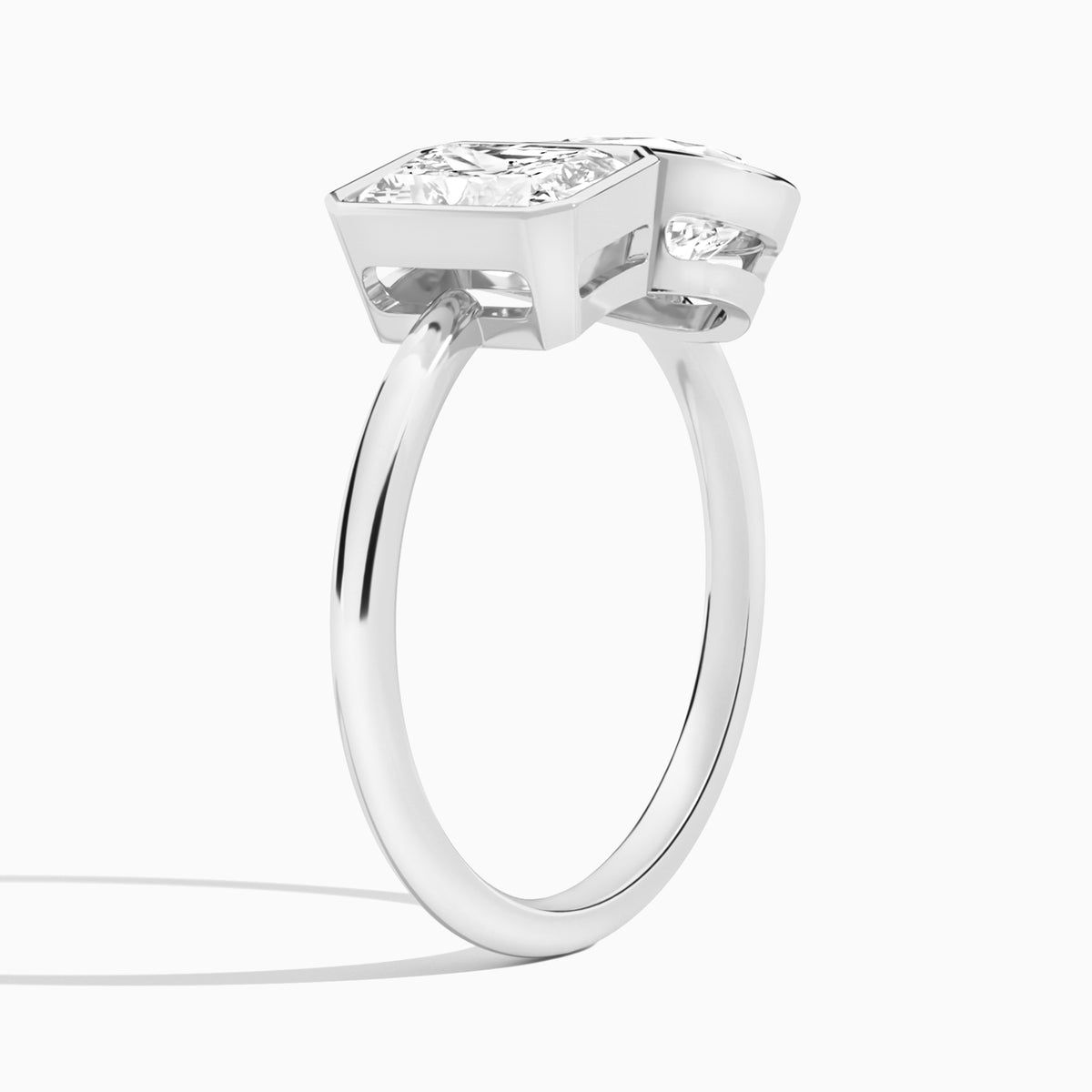 Bezel Toi Et Moi Radiant and Pear Diamond Engagement Ring In Platinum, Angle View
