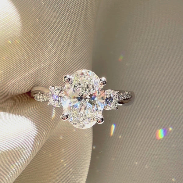 Three-stone oval engagement ring, twisted pavé diamond band, custom oval bridal jewelry, white gold three-stone diamond ring.